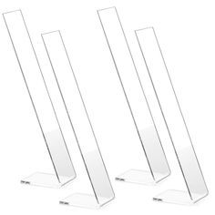 three clear acrylic pedestals are lined up in a row on a white background