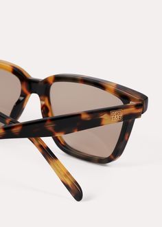 TOTEME sunglasses made in Italy with a squared acetate frame that's softened along the edges. The light brown-tinted lenses offer UV protection and can be replaced with prescription lenses, while the arms are accented with a gold-tone monogram plaque. Style them with city and vacation edits. Chic Rectangular Tortoiseshell Sunglasses, Elegant Tortoiseshell Square Frame Sunglasses, Summer Tortoiseshell Square Sunglasses, Square Tortoiseshell Sunglasses With Gradient Lenses, Luxury Tortoiseshell Glass Sunglasses, Fringed Belt, Lipstick Bag, Chain Strap Bag, Oversized Tote Bag