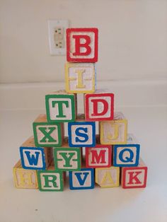 wooden blocks with letters spelling the alphabet on them