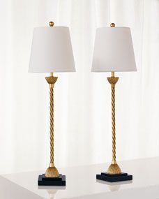 two lamps sitting on top of a white table