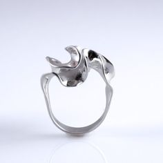 A simple band blooms into an intricate convolution of sterling silver.  This ring is 3D printed in wax, then cast in silver using lost wax casting. Also available in brass, 14k gold, 18k gold, palladium, and platinum by special order.Our Florescence collection is inspired by the biomechanics of growing leaves and blooming flowers. Each piece emerges from a computational simulation of differential growth, a surface that grows at different rates in different location. The flowering structures expa Hand Forged Sterling Silver Modernist Rings, Modernist Hand Forged Sterling Silver Rings, Modern Hand Cast White Gold Ring, Formal Hand Cast Sterling Silver Rings, Modernist Hand Cast Sterling Silver Rings, Modernist Hand Cast Ring As Gift, Modernist Hand-cast Jewelry Ring, Hand Cast Modernist Ring As Gift, Hand Cast White Gold Rings For Anniversary