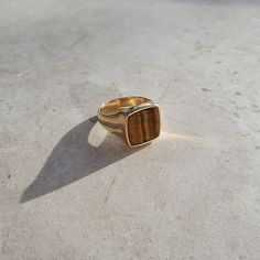 This ring is a one-of-a-kind and genderless piece made with Recycled Sterling Silver 925 Gold Vermeil.  DETAILS Stone: Tiger's Eye Material: Sterling Silver 925 and Gold Vermeil If you would like to wear this ring as a wedding band we could make it in a solid gold, any questions send a message for a quotation.   It has a 1-year guarantee and lifetime assistance. The ring comes without engraving, but if you would like it engraved, please just follow our listing for engraving: https://www.etsy.com Refined Ring With Polished Finish As Gift, Refined Ring With Polished Finish For Gift, Refined Gift Ring With Polished Finish, Modern Yellow Gold Rings With Gemstone, Modern Yellow Gold Ring With Gemstone, Modern Timeless Design Jewelry Ring, Modern Signet Ring With Gemstone, Modern Gemstone Open Signet Ring, Modern Open Signet Ring With Gemstone