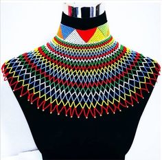 This handmade South African necklace will add a special african touch to any outfit. It is available in Black and white, black and gold, rainbow colours. Zulu Beads, Zulu Necklace, Handmade Dreadlocks, Xhosa Attire, African Beaded Necklace, Beaded Shawl, South African Traditional Dresses, African Beads Necklace, African Hats