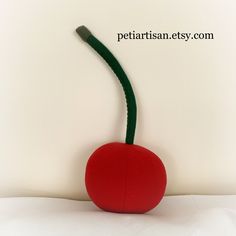 "This cute Cherry Pillow will brighten up any room! It is a delightful decor for a living room, play room, nursery, beach houses, etc. The pillow is handmade from soft fleece and filled with non-allergenic fiberfill. The one cherry comes with a wire in the stem. The two cherry pillow has a fabric stabilizer inside. I can insert wire by request but this makes the pillow not suitable for children. Size - diameter of each cherry 7\",about 19\" toll with the stems All products are handmade by me in Cherry Pillow, Fruit Pillow, Food Pillows, Novelty Pillows, Strawberry Color, Sophomore Year, Pillow Texture, Red Strawberry, Cool Kitchen Gadgets