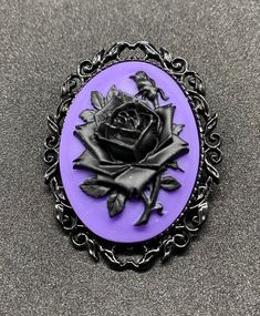 Purple and black rose resin cameo, set in black metal alloy pin back setting.  Cameo is 40x30mm, please see pics for coin comparison. Black Brooch Lapel Pin As Gift, Black Lapel Pin Brooch As Gift, Black Lapel Pin Brooch For Gift, Vintage Black Lapel Pin As Gift, Vintage Black Lapel Pin For Gift, Black Vintage Lapel Pin For Gift, Vintage Black Brooch Lapel Pin, Black Gothic Jewelry Brooch, Black Gothic Brooch Jewelry