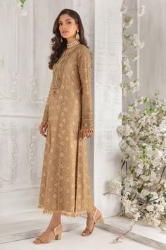 Crafted on luscious Pure chiffon canvas, this A-line shirt features embellished neckline and sleeves with dabka, pearls, beads and tila work. This exclusively curated shirt is further highlighted with laboriously detailed tasseled border on hem and sleeves to add glamour and oomph. Off set with pure chiffon sequin and bead embellished dupatta with beautifully composed border and Gold jamawar straight pant. Shirt Fabric: Pure Embroidered chiffon Shirt Length: 48” (Customisable, mention in order n Designer Outfit, Embellished Neckline, Embroidered Chiffon, Pure Chiffon, Pakistani Designers, Shirt Fabric, Chiffon Shirt, Pant Shirt, Shirt And Pants