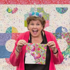 a woman holding up a piece of paper in front of her face and making a funny face