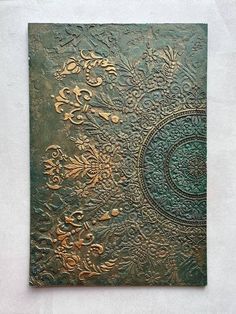 an intricately designed metal plate on a white wall