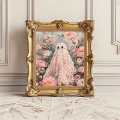 an ornate gold frame with a painting of a ghost surrounded by pink flowers on a marble floor