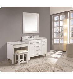 a white bathroom vanity with two stools and a mirror on the wall above it