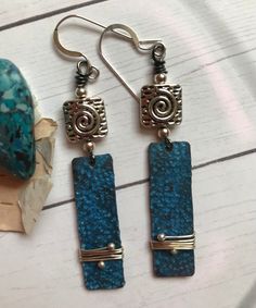 As blue as the water in the pool, these sunny, lightweight earrings combine Silver and Blue to perfection. The copper patina charms are textured and wrapped. The earrings measure 2-1/4 inches long. Silver findings and ear wires. Copper Wire Crafts, Copper Patina, Moon Glow, Vacation Mode, Wire Crafts, Lightweight Earrings, In The Pool, Light Weight Earrings, Copper Wire