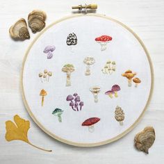 an embroidery kit with mushrooms and leaves on it