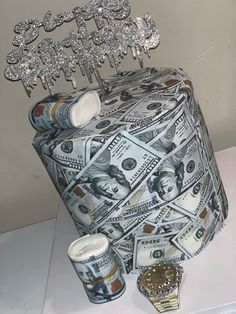 a money box made out of dollar bills and some other things on top of it