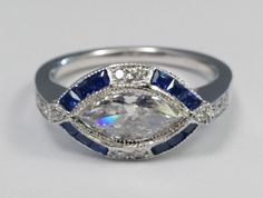 an oval shaped diamond and blue sapphire ring