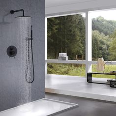 a bathroom with a large window and a shower head in the middle of the room