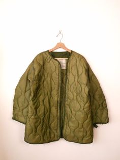 "Unworn-Vintage US Military Jacket Lining/Army Quilted Liner. Measurements Tagged size : Extra Small ( it runs bigger. Please check the measurements below.)  Length: 31\" Armpit to armpit: 24\" Shoulder: 20\" Shoulder to end of sleeve: 22\" Condition: Unworn. A thread on armpit is undone as shown in the last pic.  ※Please read the policy before you purchase※" Vintage Khaki Outerwear For Winter, Vintage Olive Long Sleeve Outerwear, Vintage Khaki Winter Outerwear, Vintage Khaki Fall Outerwear, Olive Vintage Long Sleeve Outerwear, Vintage Winter Outerwear, Vintage Green Winter Outerwear, Vintage Lined Outerwear For Winter, Vintage Lined Winter Outerwear