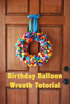 a birthday balloon wreath is hanging on the front door to give someone a happy birthday