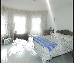 two stuffed animals are on the bed in this room with white walls and wood floors