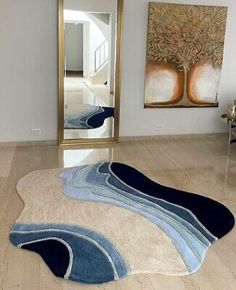 a living room with a large mirror and rugs on the floor in front of it