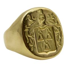 This 18k gold Tiffany & Co. Larter & Sons signet ring is hand carved with a heraldic family crest. The crest has a shield with three bell-like shapes sprouting flowers. Above the shield is a knight’s helmet topped with a feather and surrounded by scrolling foliate. The classic design of the crest suggests royalty and valor.  Larter & Sons was founded in 1865 and was renowned for their exquisite craftsmanship of men’s accessories. They expanded to include women’s jewelry in the early 20th century, using intricate techniques such as guilloche and enamelwork, and incorporating motifs inspired by nature. They collaborated with Tiffany & Co. to make jewelry such as cufflinks and signet rings. Tiffany & Co. would often consign well-known brands of the highest quality, including Larter & Sons. Classic Ceremonial Signet Ring With Polished Finish, Classic Engraved Ceremonial Signet Ring, Classic Engraved Signet Ring For Ceremonial Occasions, Classic Engraved Signet Ring For Ceremonial Use, Classic Oval Ceremonial Signet Ring, Classic 14k Gold Signet Ring For Ceremonial Occasions, Ceremonial 14k Gold Signet Ring With Polished Finish, Formal Yellow Gold Signet Ring With Coat Of Arms, Formal Yellow Gold Engraved Ring With Coat Of Arms