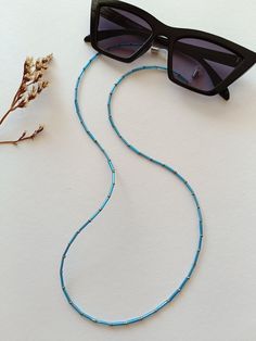 An elegant Eyeglass chain for your sunglasses or reading glasses. Approximately size of the chain is 65cm. It comes with a glasses connector that is removable. Blue Glasses Chains With Colorful Beads For Beach, Blue Beaded Glasses Chain For Beach, Blue Glasses Chains For Summer Beach, Blue Glasses Chains For Beach Summer, Blue Glasses Chains For Beach In Summer, Blue Beaded Chain Glasses Chains With Round Beads, Blue Beaded Glasses Chains, Blue Glasses Chain With Colorful Beads As Gift, Blue Glasses Chain With Colorful Beads For Gift