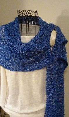 HAND CROCHETED SHAWL, WRAP, SCARF IN ROYAL BLUE AND WHITE This is a beautiful shawl made with a fine acrylic yarn. It is very big and can be worn in so many different ways. Since it is lightweight, it can be worn for all seasons. The color is blue with white running through it.  It measures approximately 16 ins. wide and 64 ins. long. Looks great with jeans and light enough to wear inside during the winter. Hand wash, lay flat to dry. A great gift! SHAWL PIN NOT INCLUDED. All items made in a smo Blue Hand Knitted Winter Shawl, Hand Knitted Blue Winter Shawl, Hand Knitted Blue Shawl For Winter, Hand Knitted Blue Shawl One Size, Handmade Blue Shawl For Winter, Blue Crochet Shawl One Size, Blue Crochet Yarn Shawl, Blue Shawl Wrap, Handmade Blue Yarn Scarves