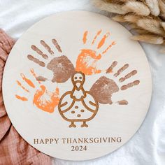 a handprinted turkey ornament with the words happy thanksgiving