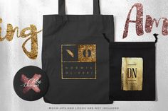 a black bag with gold foiling on it and some other items next to it