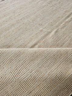 a close up view of a bed with a brown and white blanket on top of it