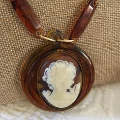 "Handmade Celluloid Cameo Gold Metal Necklace. Repurposed Old Broken Cameo Necklace With Celluloid Chain Additions. This Lovely Piece Can Continue to be Enjoyed as a Remade Piece. Brown Marbleized Celluloid Cameo PENDANT on Accented Chain. Extra O Rings Added to Adjust the Necklace Length. This Old Costume Jewelry Cameo Necklace is in good shape for its age. Size: 2\" Circle Celluloid With Oval 1 1/4\" X 1 5/8\" Cameo, 32\" Accented Chain For other handmade, jewelry and vintage items see: www.Ve Vintage Brown Medallion Jewelry, Handmade Retro Resin Jewelry, Handmade Vintage Resin Jewelry, Vintage Resin Necklace As Gift, Vintage Resin Necklace For Gift, Old Costume, Paper Feathers, Metal Necklace, Cameo Necklace