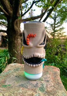 a cup that has been decorated to look like jack skellingy with an orange nose