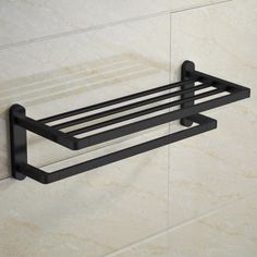 a black towel rack mounted to the side of a wall