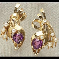 14k Yellow Gold Screw Back Earrings Depicting A Floral Bouquet Design. Each Earring Is Set With One Heart Shaped Faceted Amethyst Measuring 7mm And Four 2.5mm Pearls. 1 And 3/8 Inches And 8.6 Grams. In Very Excellent Condition! Luxury Purple Earrings For Anniversary, Amethyst Earrings Fine Jewelry For Formal Occasions, Formal Purple Clip-on Jewelry, Purple Fine Jewelry Earrings For Formal Occasions, Yellow Gold Amethyst Earrings Hallmarked, Purple Oval Earrings For Weddings, Elegant Purple 14k Gold Earrings, Elegant Purple Clip-on Earrings, Purple 14k Gold Earrings With Prong Setting