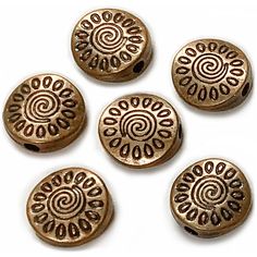 six bronze colored metal buttons with spiral designs