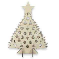 a wooden christmas tree that has holes in the middle and numbers on it, as well as an ornament