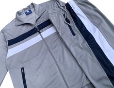 Fitted Casual Track Jacket For Jogging, Casual Stretch Track Jacket For Jogging, Gray Tracksuit With Pockets For Sports, Athleisure Track Jacket With Double-lined Hood For Sports, Sporty Gray Tracksuit With Pockets, Gray Relaxed Fit Sporty Tracksuit, Sporty Gray Relaxed Fit Tracksuit, Gray Relaxed Fit Sportswear Tracksuit, Moisture-wicking Hooded Tracksuit For Sports