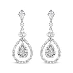 Let the sparkle of diamonds enhance your every look! Glimmering prong-set round diamonds adorn polished 18k white gold, giving you a stunning look of sophistication. These diamonds total 1 1/4 cttw with an approximate F-G Color and VS1-VS2 Clarity. The silhouette features an intricate upper dangle set with diamonds clusters above a single round diamond encases in a secure bezel setting with milgrain detail. Beginning the lower dangle is a trio of round white diamonds that signify the past, prese Diamond Chandelier Earrings With Brilliant Cut For Anniversary, Anniversary Diamond Chandelier Earrings With Brilliant Cut, Diamond White Diamond Chandelier Earrings, Classic Brilliant Cut Chandelier Earrings For Anniversary, Diamond White Chandelier Earrings With Diamond Cut, Diamond White Chandelier Earrings In Fine Jewelry Style, Classic White Gold Diamond Chandelier Earrings, Dazzling Diamond Teardrop Chandelier Earrings, Classic Brilliant Cut Chandelier Earrings For Formal Occasions