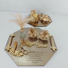 two decorative trays with gold and white decorations on them, one has a nameplate that reads royal sequins