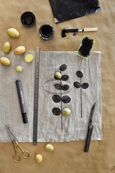 an assortment of objects are laid out on a table with scissors, tape and other items