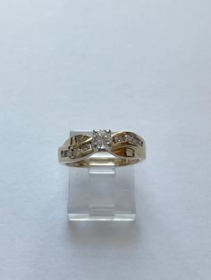 This is an absolutely beautiful vintage 14 karat yellow gold diamond wedding or engagement ring. The ring has a Centerstone that measures 1/4 carat. It is a SI, G-H  grade On either side of the Center stone are 8 smaller diamonds each .03 caret Total Diamond weight of ring is over 1/2 caret.  The ring is a size 5 1/2. It is hallmarked 14 K. It weighs 3.8 g. It is 5.6 mm wide. The stone sits 6.3 mm off the finger  This ring is an excellent preowned vintage condition with normal wear for the age. All stones are secure and the band shank shows little to no wear 14k Gold Princess Cut Diamond Ring, 14k Gold Princess Cut Diamond Ring With Single Diamond, Gold Princess Cut Diamond Ring With Single Stone, Yellow Gold Princess Cut Diamond Ring With Accents, Heirloom Gold Princess Cut Diamond Ring, Heirloom Diamond Ring Stamped 14k, Princess Cut Diamond Ring With Accents In 14k Gold, 14k Gold Single Diamond Wedding Ring For Anniversary, 14k Gold Princess Cut Diamond Ring With Accents