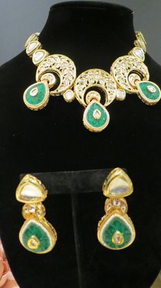 This beautiful choker is a modern twist to traditional jewelry and comes in a gold finish with green stones to match any outfit as desired. The choker is made of high quality stones and is a statement piece that can be dressed accordingly. The set comes with matching earrings for a complete look. Traditional Green Earrings With Jewels, Elegant Green Jewelry With Stone Work, Elegant Green Kundan Emerald Necklace, Traditional Green Jeweled Earrings, Elegant Green Emerald Necklace With Stone Work, Festive Green Jeweled Earrings, Green Kundan Jewelry With Matching Earrings, Green Gold-plated Kundan Necklace For Festivals, Green Gold Plated Kundan Necklace For Festivals