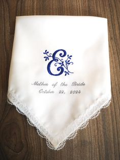 Lovely white lace wedding handkerchief with Leaf Monogram Embroidery design and wedding date.  What you will get in this purchase:- - 1 x Handkerchief with lace (12 x 12 inch)  - 1x Presentation unique white gift similar envelope, front fold flap provides a secure closure ( 5 x 4.5 inch) The final product is neatly folded in gift envelope and ready for gifting. Please leave us a note with the info below when you place your order. 1.You may choose Title below, example: Mother of the Groom, Sister of the Bride, Sister of the Groom, or just monogram, etc.. If we don't receive your request color thread for title -Mother of the Bride, we will assume everything looks good and continue with production same color with the monogram. 2.Wedding Date:  Notes:  Please double check your custom monogram Blue Embroidered Wedding Handkerchief, Blue Embroidered Handkerchief For Wedding, Blue Embroidered Handkerchiefs For Wedding, Elegant Embroidered Handkerchiefs For Bridal Shower, Elegant Customizable Handkerchiefs For Bridal Shower, Embroidered Lace Handkerchiefs For Wedding, White Embroidered Text Handkerchief Wedding Gift, Elegant Embroidered Handkerchiefs For Wedding Gift, White Wedding Handkerchiefs With Custom Embroidery