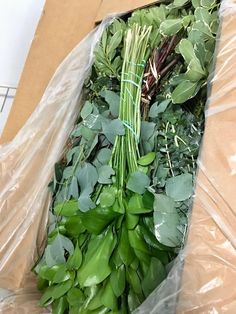 a bunch of green vegetables wrapped in plastic