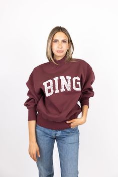 The Bradie Sweatshirt from Anine Bing is constructed from midweight cotton fleece in a deep burgundy wash. Its relaxed silhouette features an original BING graphic in contrast white, and is finished with a high mock neckline, long blouson sleeves, and ribbed trim at the hem. 85% cotton, 15% polyester. Machine wash gentle, tumble dry low. CAKE CURATED This sweatshirt is cozy yet chic. Wear over athleisure or dress it up with a pair of medium wash denim and bootie this fall. Vintners Daughter, Indie Lee, Christophe Robin, Loungewear Fashion, Deep Burgundy, Anine Bing, Mock Neckline, Skin Care Treatments, Oliver Peoples