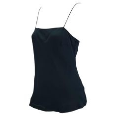 Presenting a sensual Gucci tank top, designed by Tom Ford. This uniquely shaped tank top features spaghetti straps with an a-line construction. Not your average tank top, this shirt was designed for the Spring/Summer 1997 collection and is the perfect chic elevation to the standard tank. Approximate measurements: IT42 35" bust 38" waist 24" shoulder to hem 72% rayon viscose, 28% silk Cami Top With Built-in Bra For Evening, Silk Cami Top With Built-in Bra, Sleeveless Evening Tops With Built-in Bra, Silk Cami Tank Top With Built-in Bra, Silk Tank Top With Delicate Straps, Silk Sleeveless Camisole For Summer, Formal Silk Tank Top For Summer, Silk Sleeveless Blouse Camisole For Summer, Summer Evening Camisole With Built-in Bra