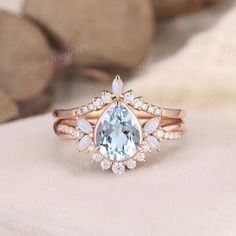 Unique Aquamarine Engagement Ring Pear Shaped Bridal Set Unique Vine Butterfly Floral Rose Gold Baby Blue Bezel Marquise Birthstone 2pcs ✦ Handmade, high-quality item ✦ Material: SOLID 10K/14K/18K GOLD ( can be made in yellow/white/rose gold ) ✦Engagement ring ✦ Center stone: Natural Aquamarine ✦ Size/Weight: 6*8mm ✦ Color: Blue ✦ Cut: Pear Shaped ✦ Side stones: Moissanite or Natural Diamonds; lab opals  ✦ Weight: About 0.3ct  ✦ Band Width: Around 1.8mm ✦Wedding band  ✦ Side stones: Moissanite o Pear-shaped Opal And Diamond Anniversary Ring, Pear-shaped Opal Ring For Wedding, Aquamarine And Opal Engagement Ring, White Opal Ring, Pear-shaped For Wedding, Elegant 14k Gold Pear-shaped Opal Ring, Engagement Ring Pear Shaped, Opal Wedding Ring Set, White Opal Engagement Ring, Ring Pear Shaped