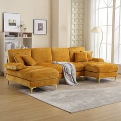 a living room with yellow furniture and white walls