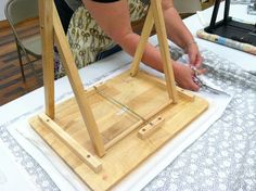 a woman is working on an art project