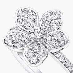 a white gold ring with diamonds in the shape of a four - leafed flower