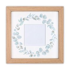 a white frame with blue flowers and leaves on it